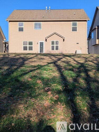 A house with a brown roof and a grey garage door.
