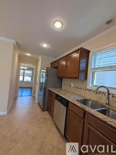 A kitchen with brown cabinets and a sink.