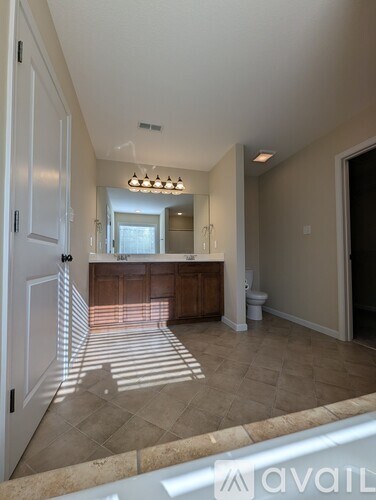 A well-lit kitchen with a bar area and a view of the dining area.