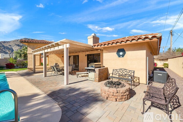 A house with a pool and patio furniture.