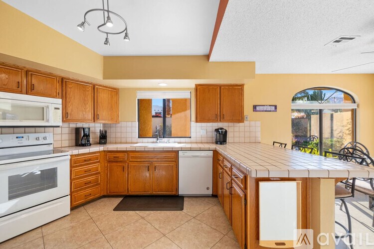 A kitchen with wooden cabinets and a white oven.