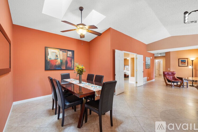 A dining room with a table set for six.