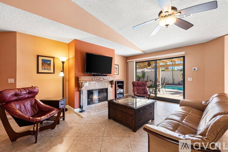 A living room with a fireplace and a television.