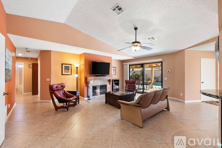 A living room with a fireplace and a television.