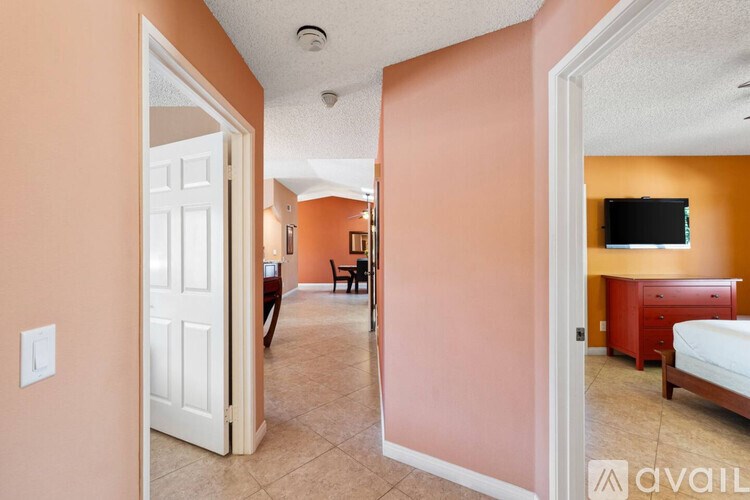 A bedroom with a bed, dresser, and chair in a house.