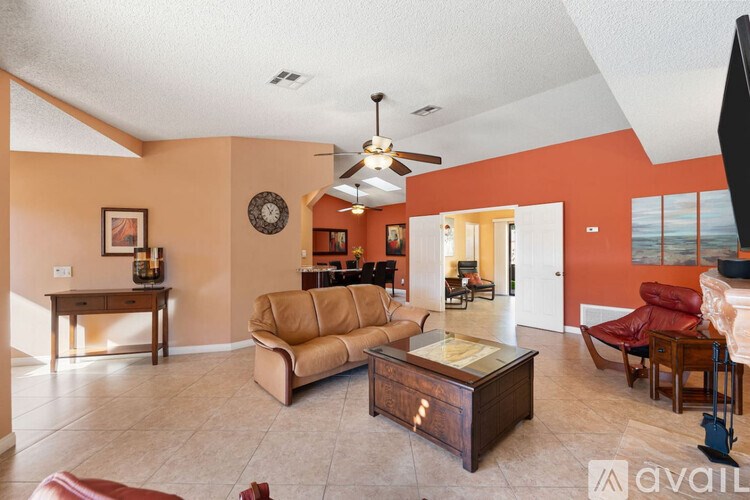 A living room with a brown couch and a wooden coffee table.