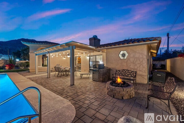 A house with a pool and a fire pit in the backyard.