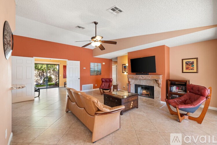 A living room with a fireplace and a television.