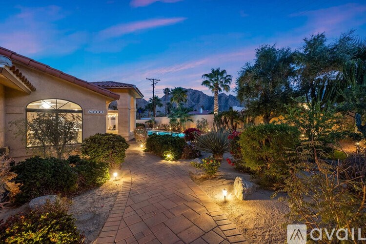 A house with a garden and a pathway leading to it.