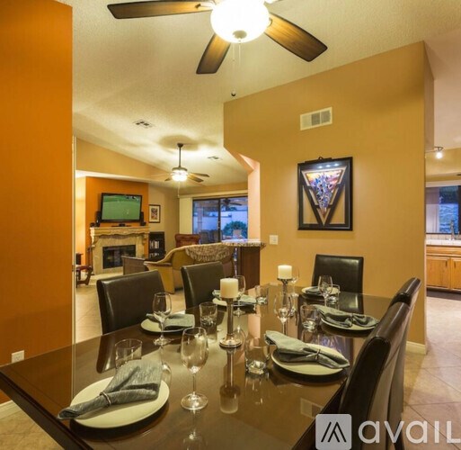 A dining room with a table set for six people.