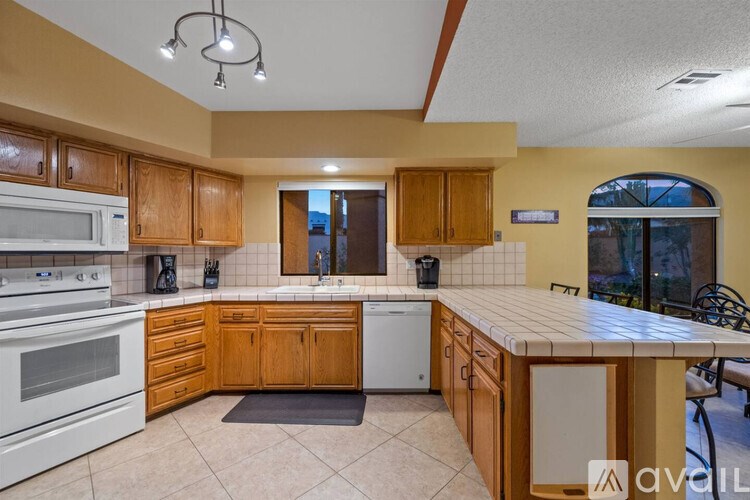 A kitchen with wooden cabinets and a white oven.
