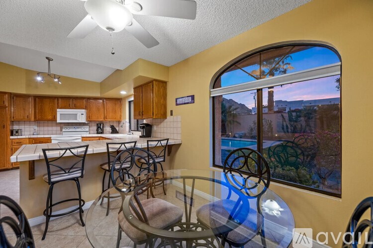 A kitchen with a table and chairs and a window.