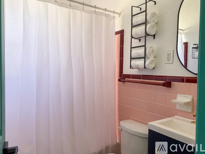 A bathroom with a toilet, sink, and a shower curtain.