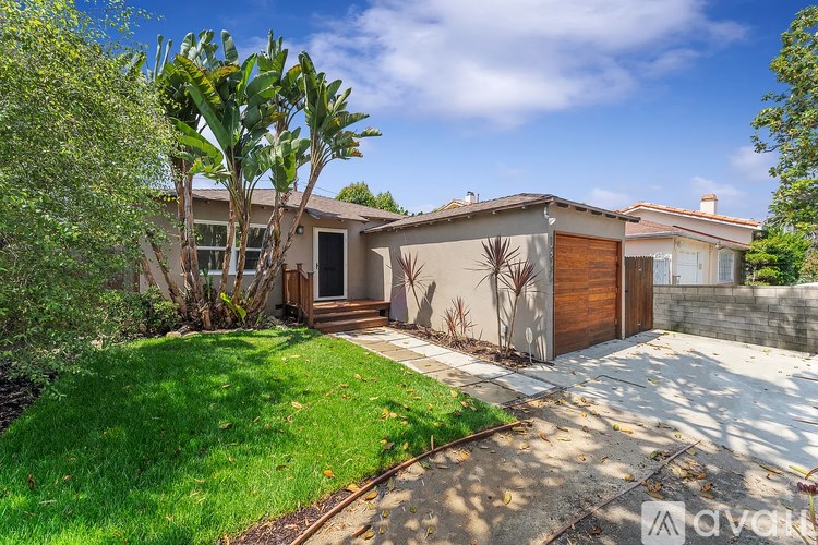 A house with a brown door and a wall with a plant design on it.