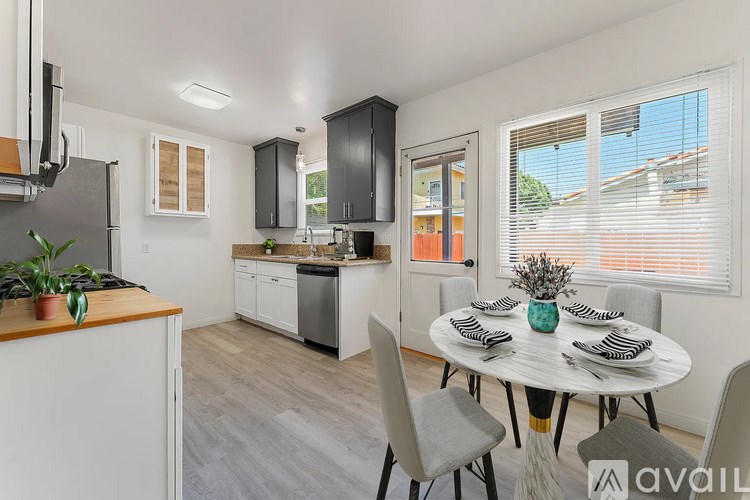 A kitchen with a dining table set for four.