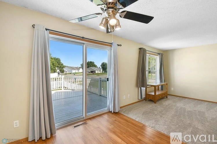 A room with a sliding glass door leading to a deck.