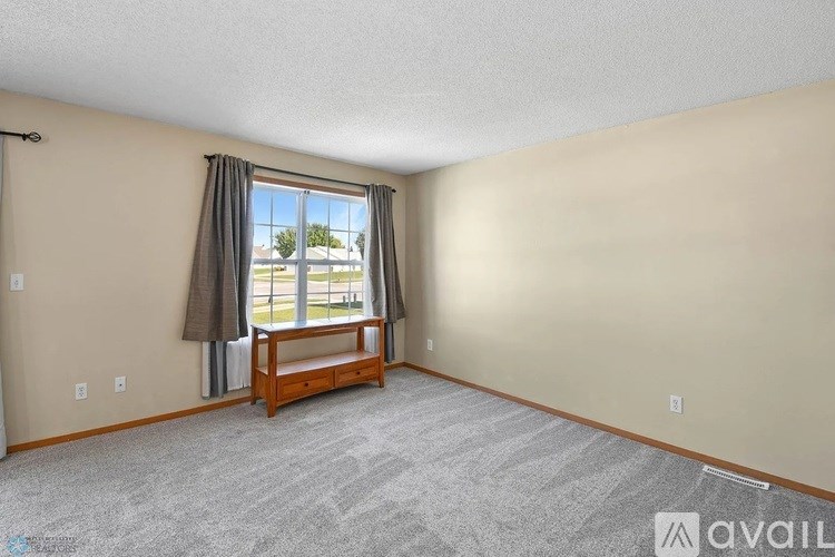 A room with a window seat and a view of the outside.