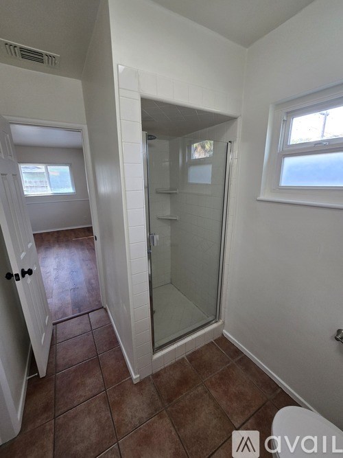 A bathroom with a toilet, sink, and shower.