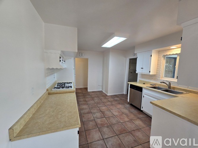 A kitchen with a counter top and a sink.