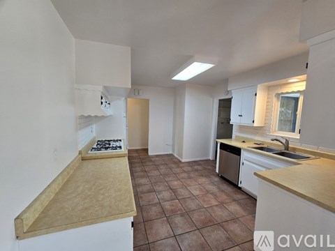 A kitchen with a counter top and a sink.