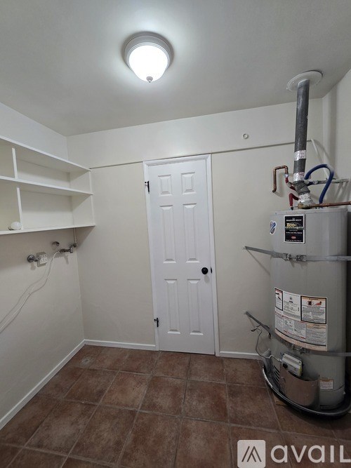 A room with a white door and a water heater.