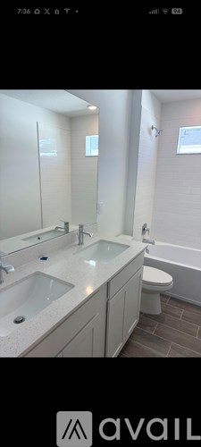 A bathroom with a sink, mirror, and toilet.