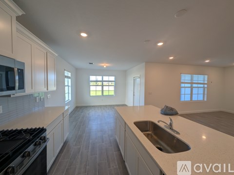 A kitchen with a black stove top oven and a white counter top.