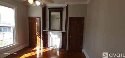 A room with a wooden floor and a large window.