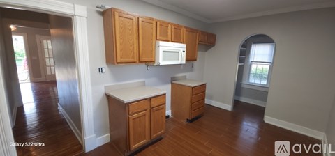 A kitchen with wooden cabinets and a white countertop.