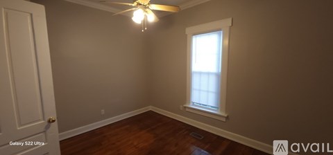 A room with a ceiling fan and a window.