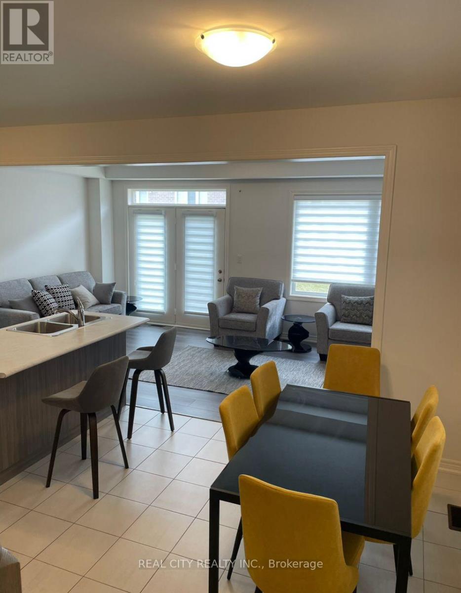 A dining room with a table and chairs.