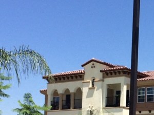 an apartment building with a pool in front of it