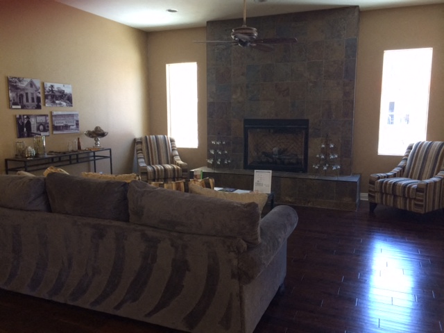 a living room with a couch and chairs and a fireplace