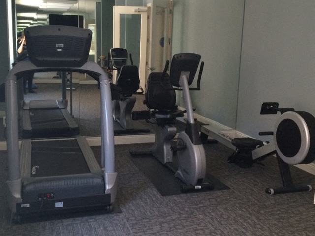a row of exercise machines in a gym