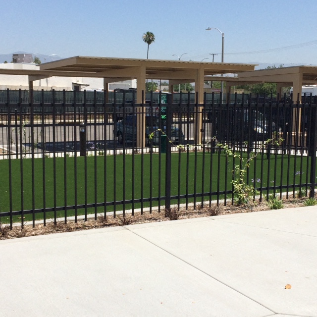 an image of a fence with a lawn in front of a building