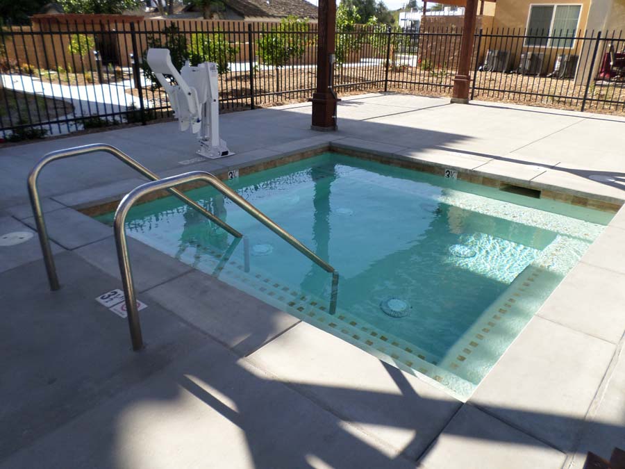 the pool is empty and has a railing around it