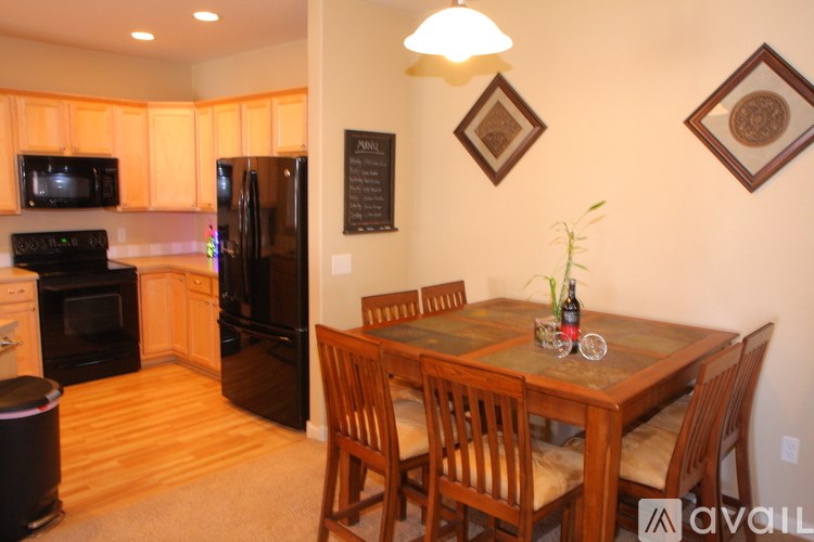 A kitchen with a table and chairs in the middle of the room.