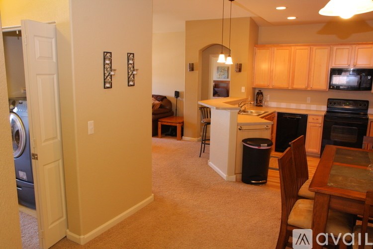 A kitchen with a washer and dryer in the laundry room.