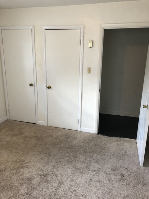 A room with two doors and one open.