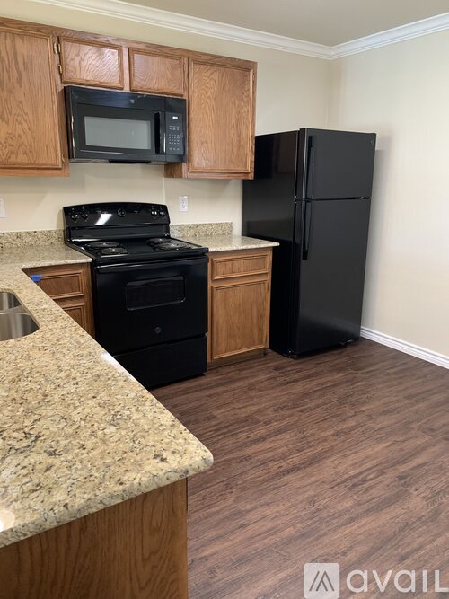 A kitchen with a black fridge and stove.