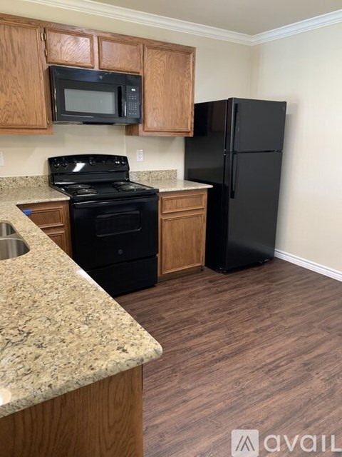 A kitchen with a black fridge and stove.