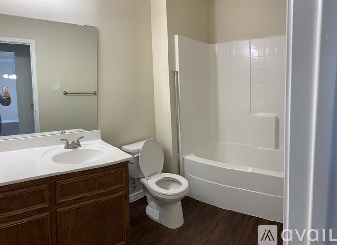 A bathroom with a toilet, sink, and bathtub.