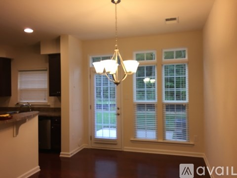 A kitchen with a chandelier hanging from the ceiling.