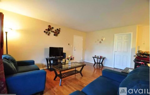 A living room with a blue couch and a coffee table.