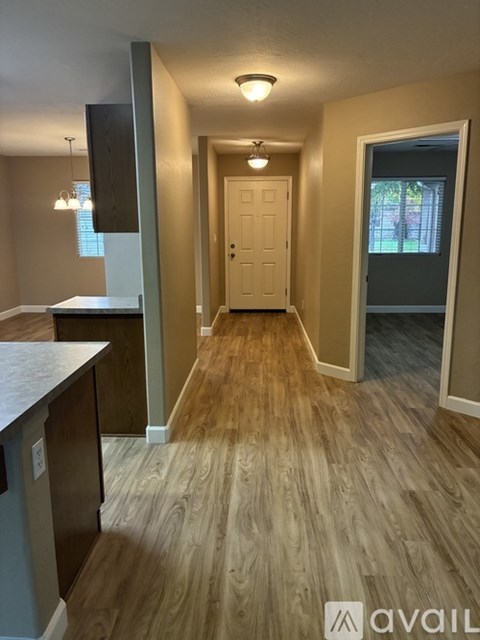 A kitchen with a fan and a counter is available for rent.