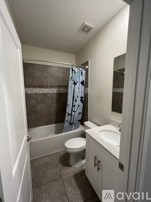 A bathroom with a toilet, sink, and bathtub.