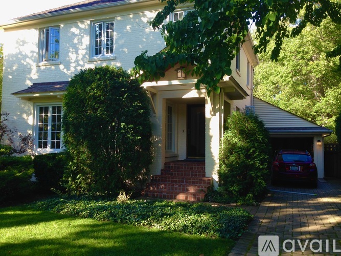 A house with a car parked in the driveway.