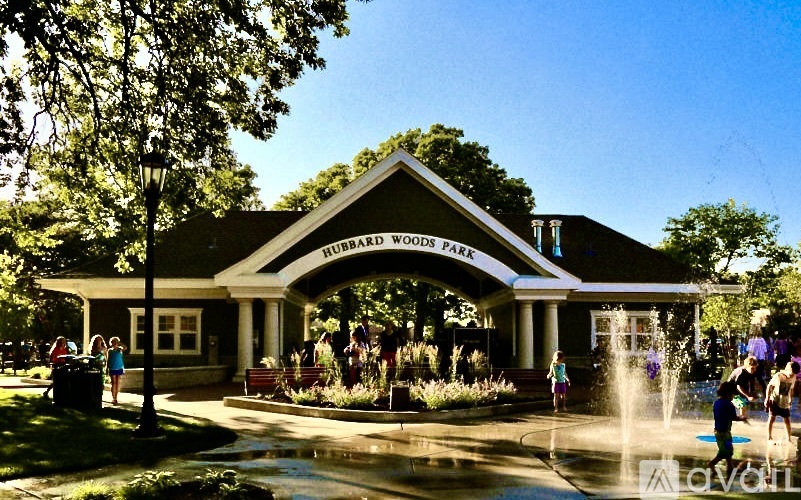 A group of people are gathered at the entrance to a building called "Humboldt Woods Park".