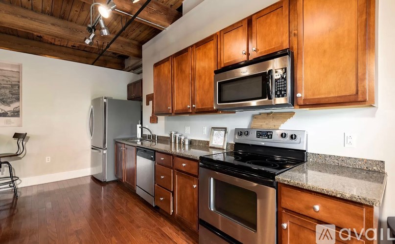 A kitchen with wooden cabinets and stainless steel appliances.
