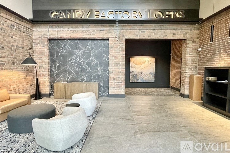 A lobby area with a stone wall and a black and white marble floor.